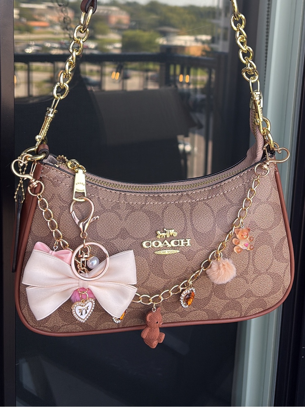 Coach Brown Signature Canvas Shoulder Bag with Pink Bow Charm